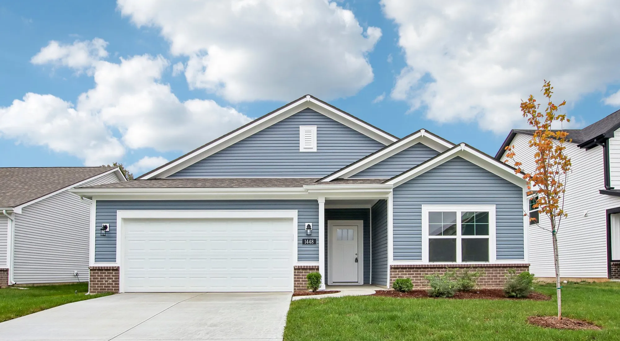 Chestnut by Arbor Homes exterior with blue siding and brick