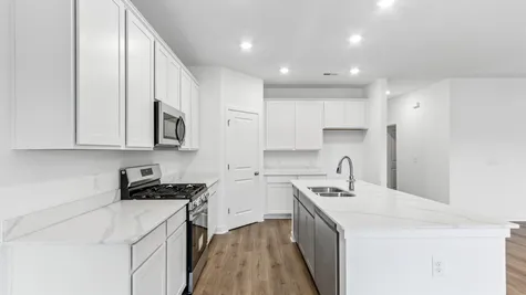 Kitchen with white cabinets and quartz countertops, Abbey Commons