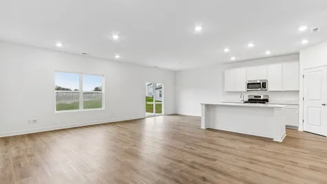 Kitchen and great room with luxury vinyl plank flooring, Abbey Commons