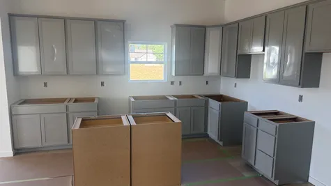 Kitchen with grey cabinets, the Bradford Floor Plan at Westfall Place